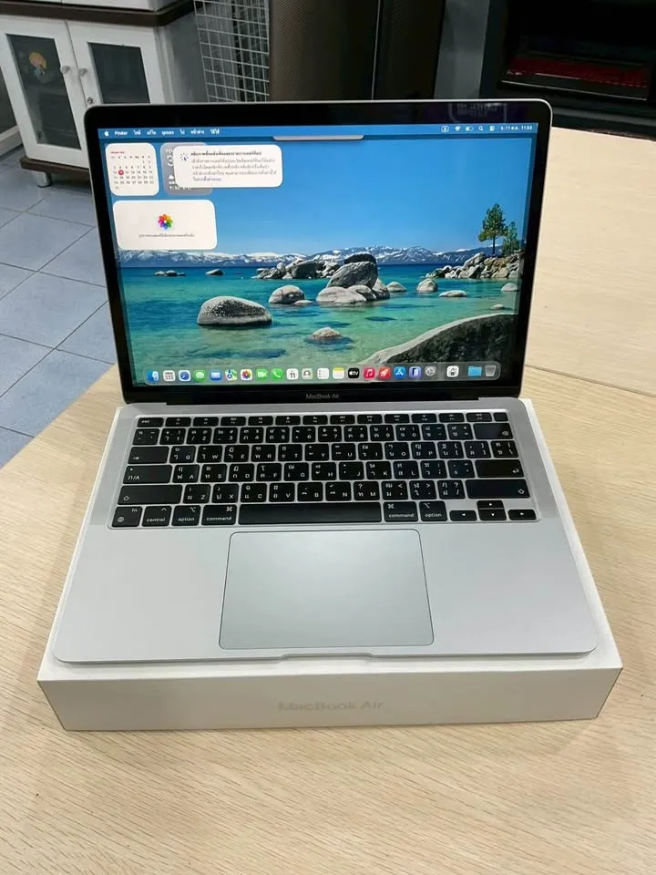MacBook Air สีเงินวางบนกล่อง เปิดหน้าจอ macOS